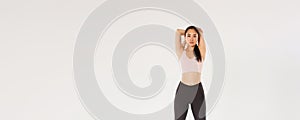 Full length of focused and motivated asian female athelte, brunette fitness girl looking determined while perform