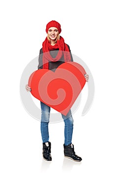 Full length girl holding up a red cardboard heart