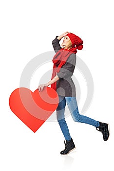 Full length girl holding up a red cardboard heart