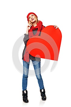 Full length girl holding up a red cardboard heart