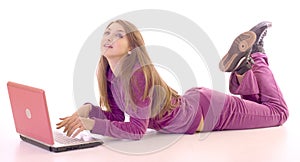 Full length of a girl lying on floor using laptop