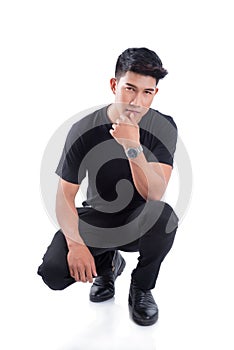 Full length of handsome man sitting over white background