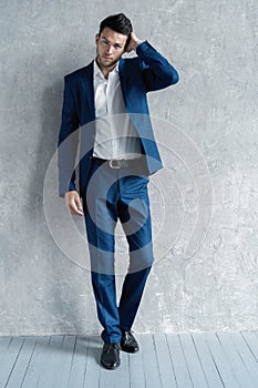 Full length of handsome man wear blue suit isolated on grey background.