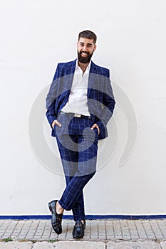 Full length happy successful businessman in blue suit