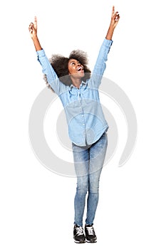 Full length happy young black woman with arms raised against isolated white background