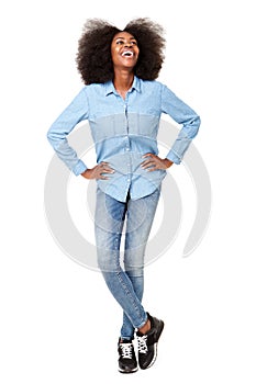 Full length happy young black woman standing on isolated white background with hands on hips