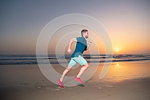 Full length of healthy man running and sprinting outdoors. Male runner. Fit male fitness runner during sunset workout.