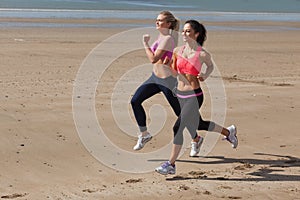 Full length of healthy women jogging on beach