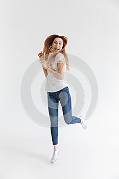 Full length image of Happy woman in t-shirt running