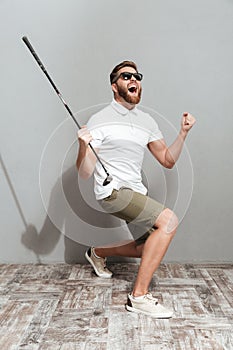 Full length image of a Screaming golfer in sunglasses