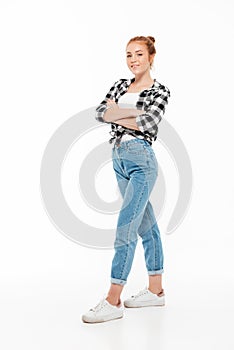 Full length image of smiling ginger woman in shirt