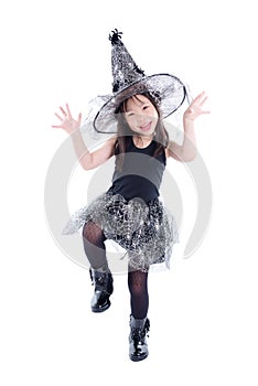 Full length of little asian girl wearing witch costume for Halloween standing isolated over white background