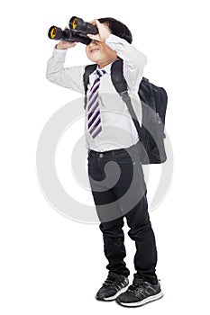 Full length of little student with binoculars