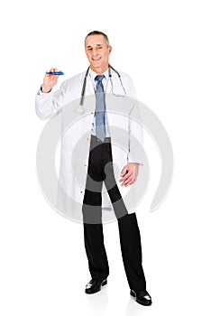 Full length male doctor holding a thermometer