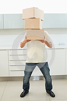 Full length of man carrying boxes in front of his face photo