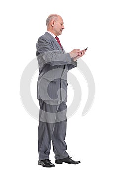 Full length mature man talking on cell phone smiling at camera
