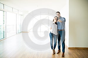 Couple Feeling Happy About Buying New House photo