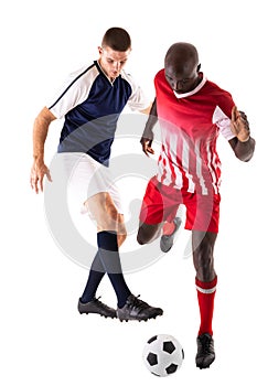 Full length of multiracial male athletes tackling soccer ball from each other over white background