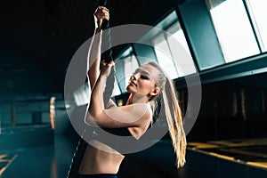 Full length narrow angle shot of a woman with climbing rope.  Copyspace background with athletics healthy composition