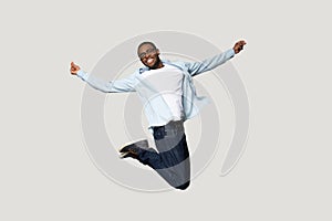 Full length overjoyed millennial african american man jumping.