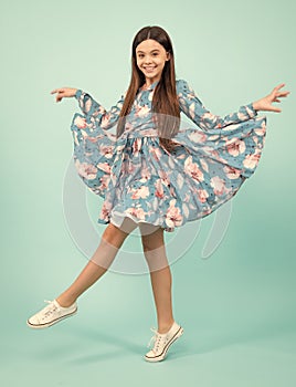 Full length overjoyed teenager kid girl 12 13 14 year jumping old isolated on blue background studio. Funny jump. Child