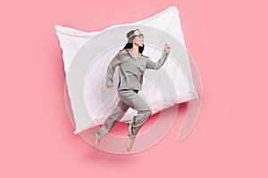 Full length photo of adorable hurrying woman nightwear mask smiling jumping high running fast  pink color