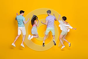 Full length photo of best buddies jump rear view raise hands up isolated bright color background