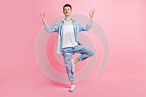 Full length photo of calm peaceful man make om sign weekend rest isolated on pastel pink color background