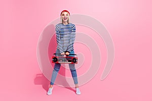 Full length photo of carefree excited girl dressed striped shirt enjoying boom box empty space  pink color