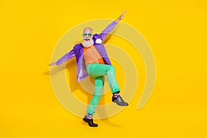 Full length photo of carefree positive pensioner wear trendy colorful outfit have fun go empty space isolated on yellow