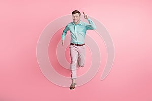 Full length photo of charismatic young man run you jump air charming smile isolated on pastel pink color background