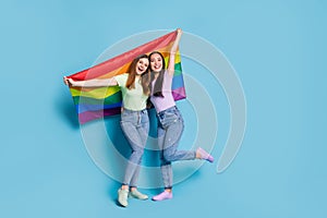 Full length photo of charming lesbians couple young ladies celebrate parade show tolerance all marriages raise gay