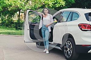 Full length photo of charming positive attractive girl buy new car salon open door stand enjoy travel automobile in city