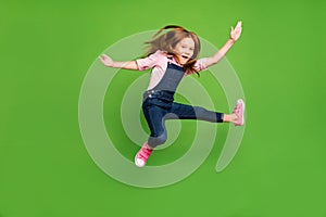 Full length photo of cheerful funny pretty little schoolchild jumping high fighting exercises training wear casual denim