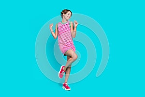 Full length photo of cheerful girl wear stylish outfit dancing night club enjoying weekend empty space isolated on cyan