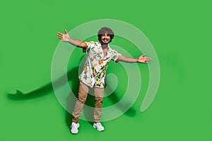 Full length photo of cool friendly latin guy dressed print shirt open arms ready hug you empty space isolated green