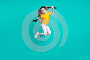 Full length photo of crazy girl jump touch her hair wear casual style outfit isolated over teal color background