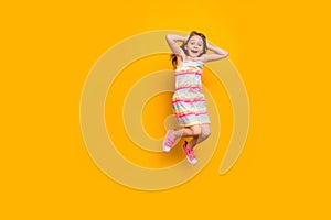 Full length photo of cute astonished child touching her head screaming shouting isolated over yellow background