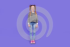 Full length photo of cute good mood little child dressed striped pullover smiling isolated purple color background