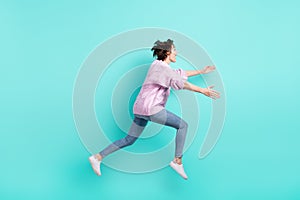 Full length photo of cute pretty woman running jumping looking empty space open arms isolated turquoise color background