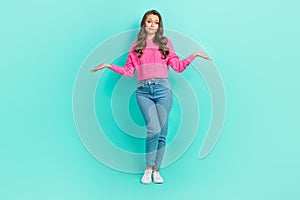 Full length photo of doubtful unsure lady dressed knitted pullover shrugging shoulders isolated teal color background