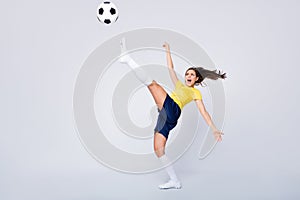 Full length photo energetic soccer player girl last hope for 2020 world championship match kick ball high try score goal