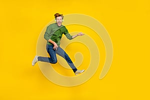 Full length photo of excited funky man wear pullover headphones playing guitar empty space isolated yellow color