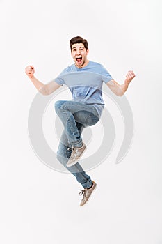 Full-length photo of excited man 30s in casual t-shirt and jeans