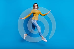 Full length photo of excited sweet lady dressed shirt jumping high running fast empty space isolated blue color