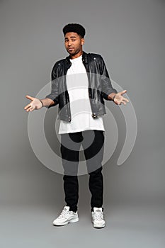 Full length photo of fashionable surprised african man standing