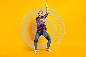 Full length photo of funky charming mature man dance cowboy rodeo rider isolated on yellow color background