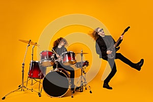 Full length photo funky crazy two people rock group team woman play drum man play bass guitar enjoy show event punk