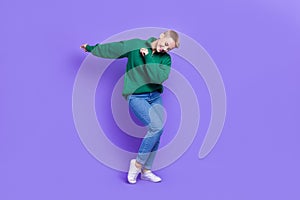 Full length photo of funky funny woman dressed green pullover dancing having fun isolated purple color background