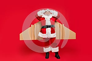 Full length photo of funky retired santa claus ready to start travel journey air flight correct his craft aviation